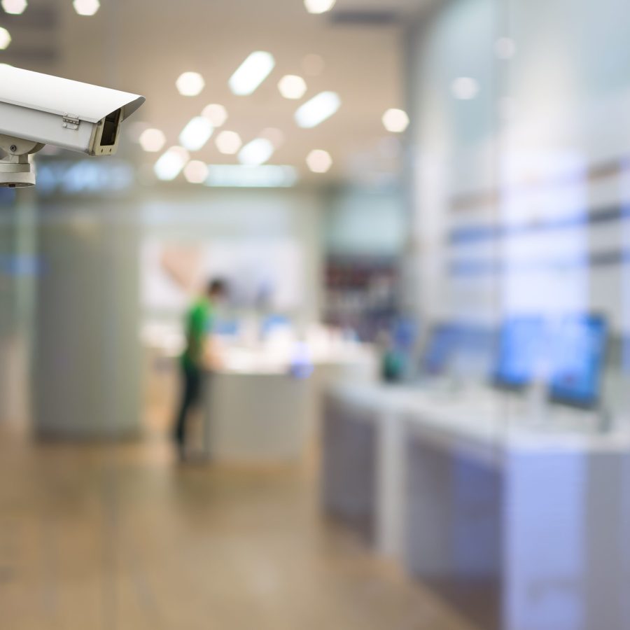 CCTV security camera on monitor the abstract store blurred in hall with bokeh background