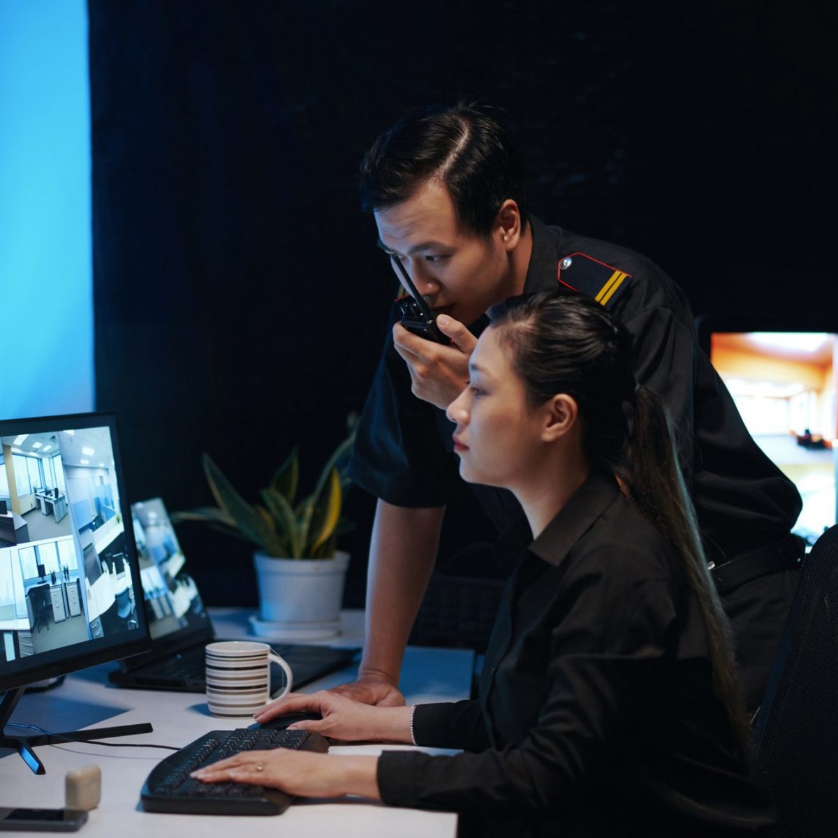 Colleagues Working In Security Room